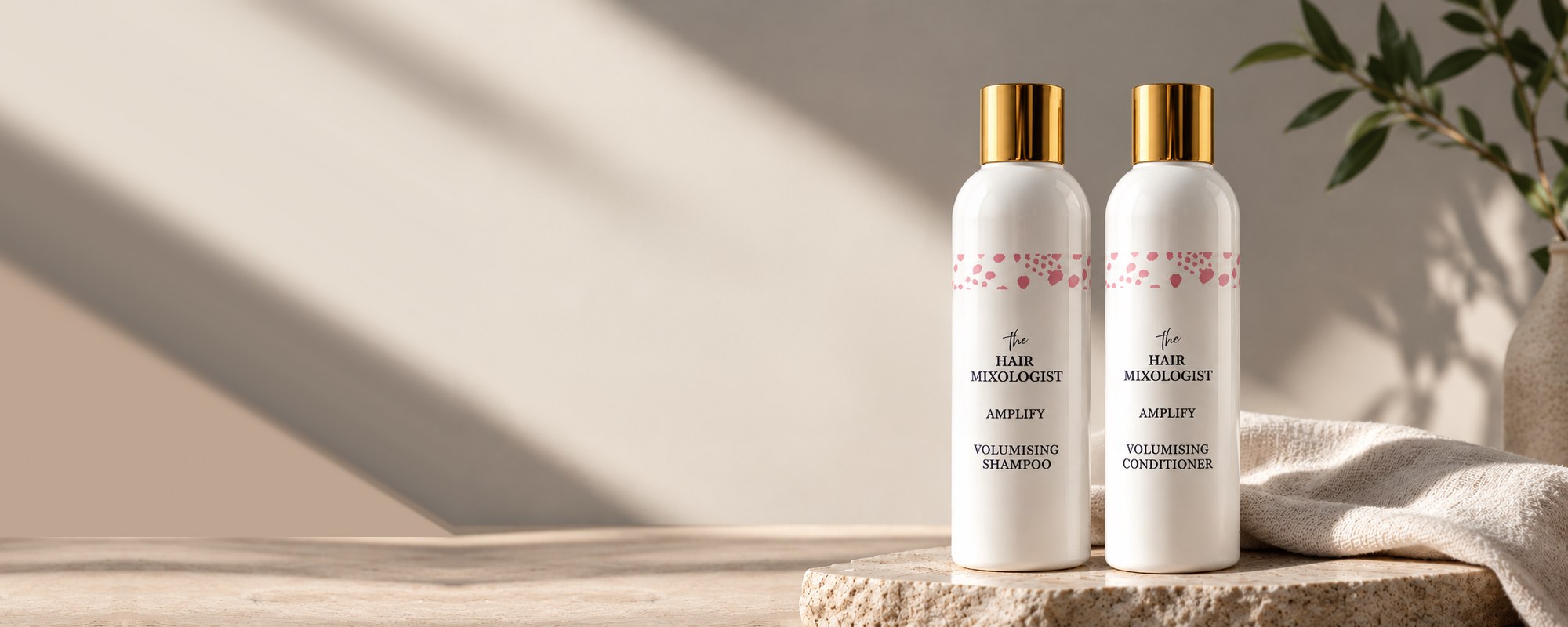 The Hair Mixologist Amplify Volumising Shampoo and Conditioner on a stone tray